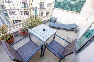 a patio with a table and chairs on a balcony at Città Studi Suites - Top Collection in Milan