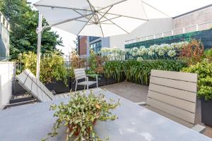 a patio with a table and an umbrella at Città Studi Suites - Top Collection in Milan