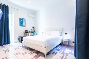a bedroom with a large white bed and a tiled floor at Città Studi Suites - Top Collection in Milan