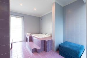 a bathroom with a white sink and a blue ottoman at Città Studi Suites - Top Collection in Milan