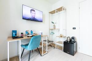 a room with a desk and a tv on the wall at Città Studi Suites - Top Collection in Milan