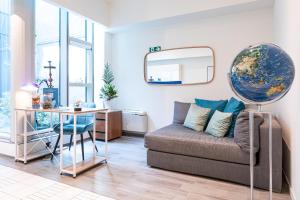 a living room with a couch and a table and a mirror at Città Studi Suites - Top Collection in Milan
