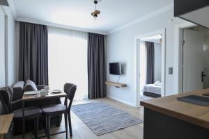a hotel room with a table and chairs and a bedroom at Deluna Yaşamkent in Çankaya