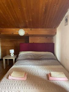 a bed in a room with a wooden ceiling at Dejan Apartments-Top centar-Old town-Low budget Studios in Pula