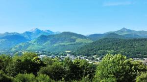 a town in a valley with mountains in the background at Caoubère in Bagnères-de-Bigorre