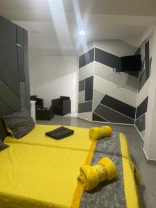 a room with two beds with yellow covers on the floor at Bluxury in Kumanovo