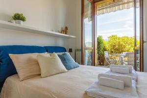 a bedroom with a bed with a view of a patio at "Panorama sul Lago" Lake Maggiore, Free Wifi Netflix and Tennis in Brezzo +17 photos