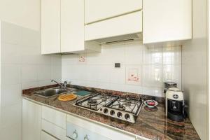 a kitchen with a stove top and a sink at "Panorama sul Lago" Lake Maggiore, Free Wifi Netflix and Tennis in Brezzo