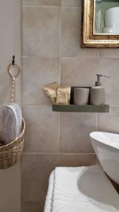 a bathroom with a sink and a toilet and a mirror at Le case di Papà Nuccio in Pietrabbondante +14 photos