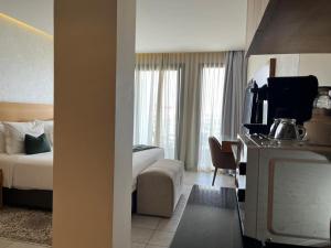 a hotel room with a bed and a television at Maarif Home Casablanca in Casablanca