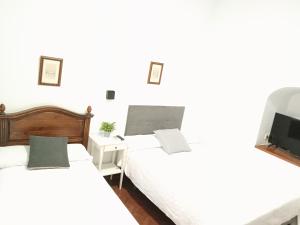 Posteľ alebo postele v izbe v ubytovaní Hostal Cuzco