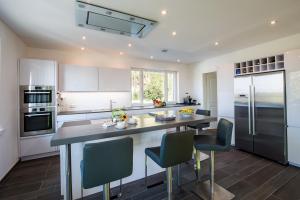 a kitchen with a large island in the middle at View & Garden Villa Schauenstein in Schauenstein
