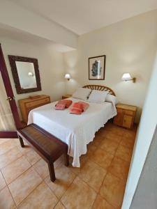 a bedroom with a white bed with two pillows on it at Mirador de Las Salinas in Los Cancajos +43 photos