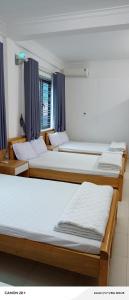 a group of four beds in a room at Night Market Heart Hotel MC in Mộc Châu