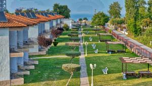 a view of a park with trees and benches at Olympion Melathron Villas in Platamonas