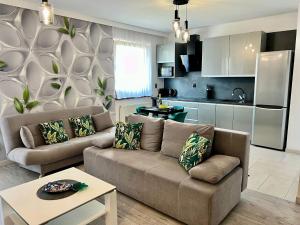 a living room with a couch and a kitchen at Apartament Eva 2 in Jelenia Góra
