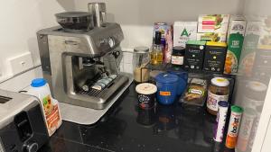 a kitchen counter with a coffee maker and food at Private room in homestay in Ashhurst