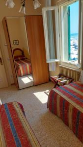 Postel nebo postele na pokoji v ubytování Albergo Regina
