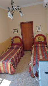 Postel nebo postele na pokoji v ubytování Albergo Regina