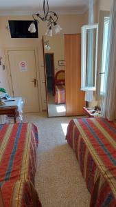 Postel nebo postele na pokoji v ubytování Albergo Regina
