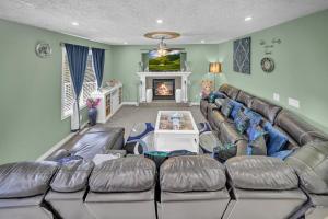 a living room with a large couch and a fireplace at 48a Luxury Lake Home W Massage Meditation Gym Ac in Calgary