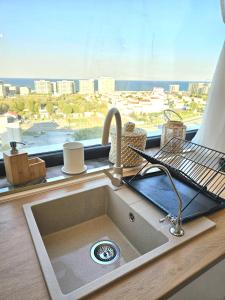 a kitchen sink in front of a window with a view at Marianne, Apartament 2 Camere, Stefan Lake 2, Mamaia Nord in Năvodari +60 photos