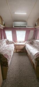 a small room with two beds and a window at Kemping Pod Babią Górą in Zawoja