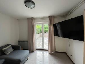 a living room with a large flat screen tv at Yellow submarine - whole house in Premantura