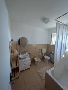 a bathroom with two toilets and a sink and a tub at Yellow submarine - whole house in Premantura +42 photos