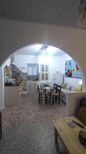 a living room with a table and a couch at Chrisi's and Jasmin's house in Patmos
