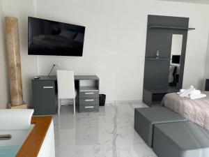 a bedroom with a desk and a bed and a desk at Casa MarFe in Grottaglie