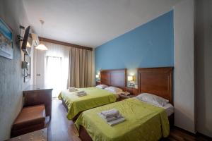 Postel nebo postele na pokoji v ubytování Hotel Olympion + 37 fotografií