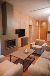 a living room with a couch and a coffee table at Hotel Ehden in Ehden