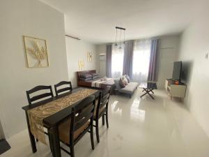 a living room with a dining table and a couch at spacious condo unit 1P olvera residences in Bacolod