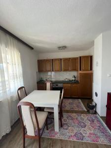 a kitchen with a table and chairs in a room at Big City House in Bihać
