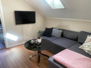 a living room with a couch and a table at Modern Fishermans Cabin in Ballstad