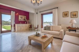 a living room with a couch and a table at Nikola's Villa Stalos Chania in Stalos