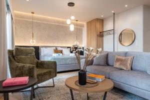 a living room with a couch and a bed at Derouse Eva Suite Jacuzzi & Sauna in Athens