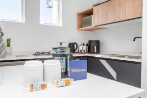 a kitchen with a counter with a box on it at Flamingo on Hope in Cape Town