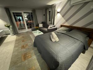 a bedroom with a bed and a living room at Ferienhaus Bilice - Pool beheizt - Fitness - Relax in Bilice +159 photos