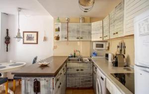 a kitchen with white cabinets and a counter top at Charming apartment in Calella de palafrugell in Palafrugell