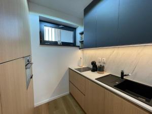a kitchen with a sink and a counter top at PENATI GOLF Apartment in Šajdíkove Humence