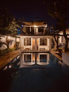 a house with a swimming pool at night at SafariVITA Villa in Moshi