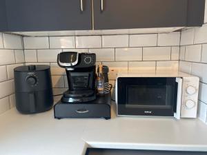 a kitchen counter with a coffee maker and a microwave at Holywood Halt in Holywood