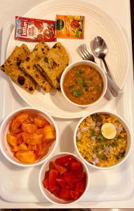 a plate of food with different types of food at Hotel Embassy Park - BKC Mumbai in Mumbai