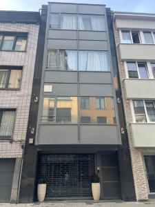 a man looking out the window of a building at Boutique Diamond Apartments in Antwerp