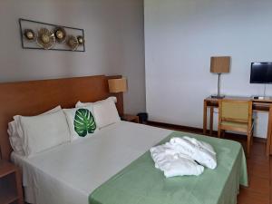Postel nebo postele na pokoji v ubytování Bamboo Xaguate Hotel