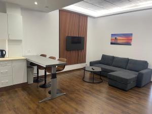 a living room with a couch and a table at Boutique Diamond Apartments in Antwerp