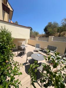 a patio with tables and chairs on top of a building at Residenza Gurnea - Free Private Parking in Tropea