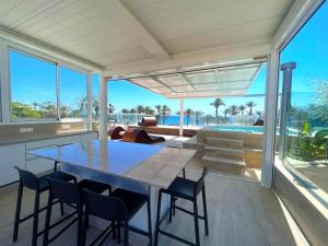 a dining room with a large table and chairs at Casa Mirabelle, a La Azohia dream by the sea in Cartagena